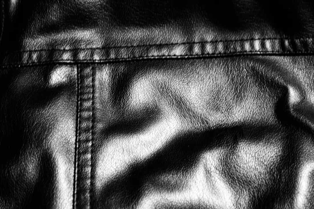 Close-up of black leather with visible stitching